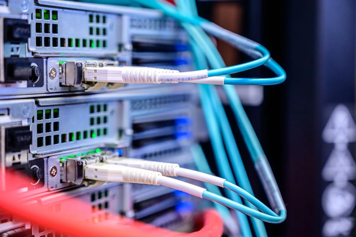 Cables connected to network equipment; stock photograph, not Microsoft facilities.